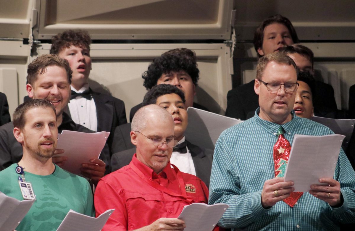 Faculty members sing along with Choir for their Christmas concert on Dec. 14, 2021. The Christmas concert is always held with a sing along with all faculty and Choir members willing to participate. 