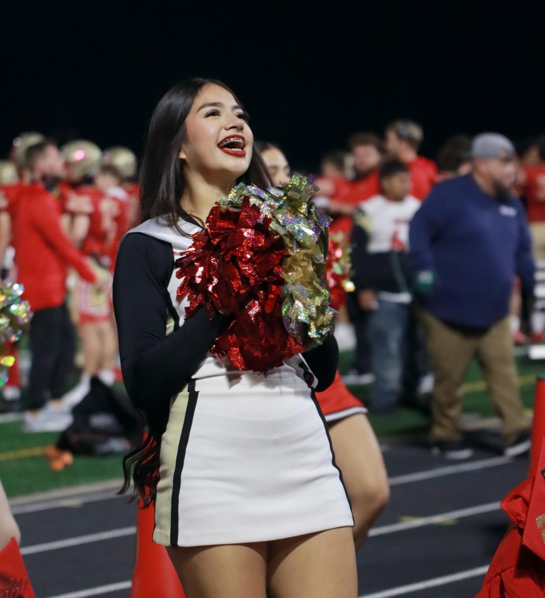 Senior Elizabeth Cervantes chants for the football team during their game against New Caney Friday, Nov. 3, 2023. Cheerleaders bring school spirit and help keep the crowd interacted through the games.