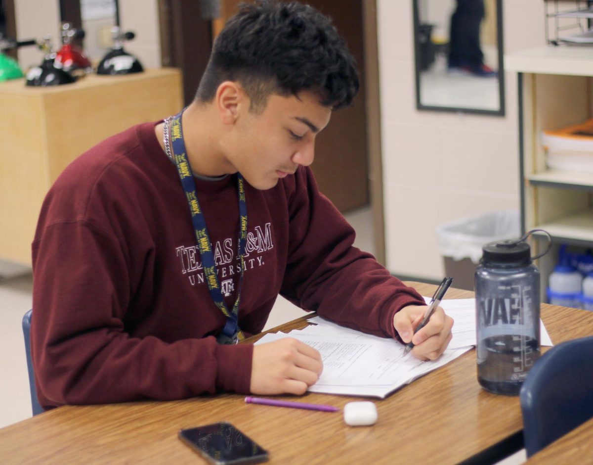 Senior Cristian Mazariegos fills out an application scholarship form on Friday, Nov. 17, 2023. Mazariegos wants to study at a Naval Academy to major in aerospace engineering. “I think the Naval Academy is a good resource that I want to take advantage of,” Mazariegos said. “The Naval Academy provides excellent education and military training as well as various opportunities for a career in the naval service.”  

