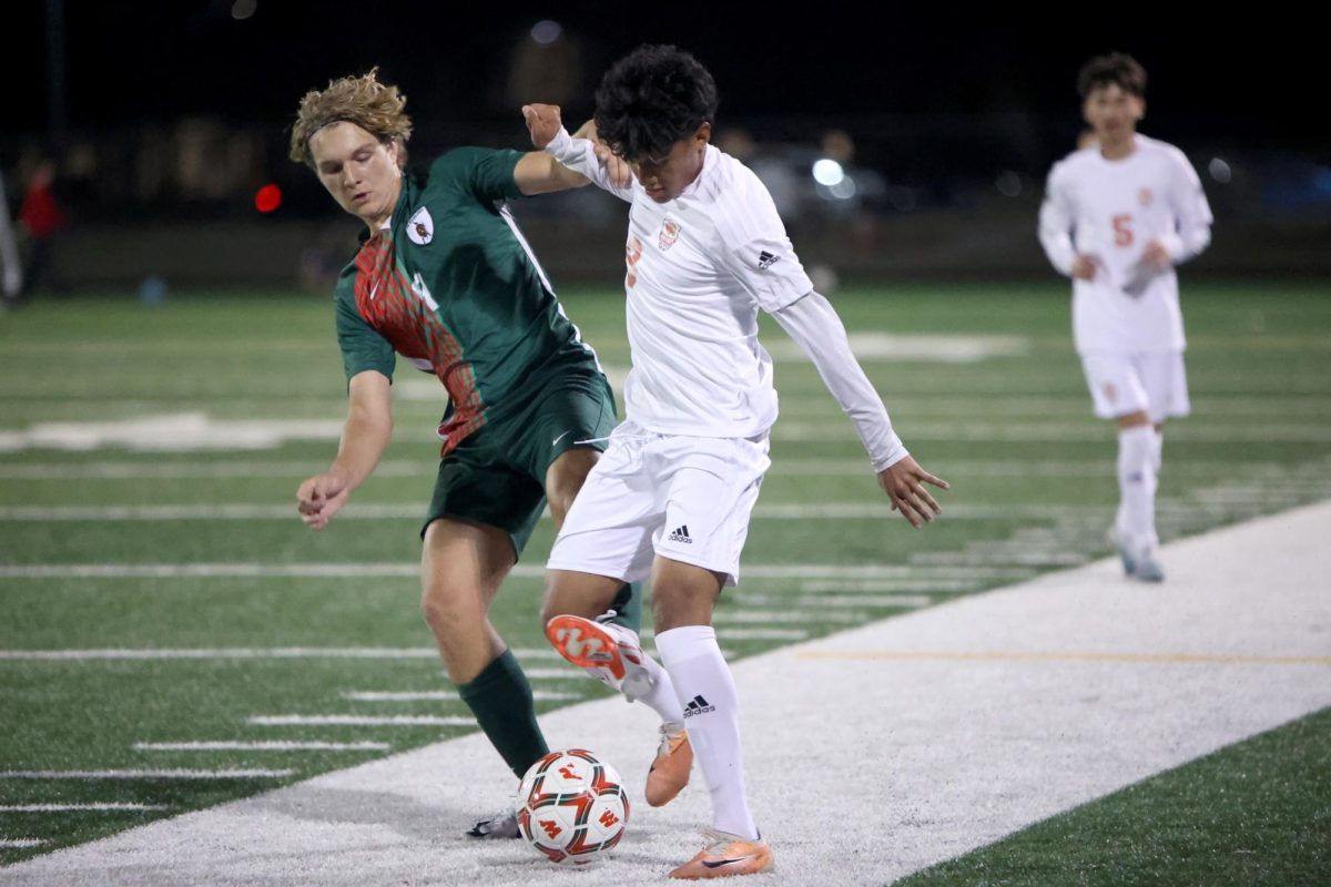 BALL WINNER. Senior Asaf Flores bumps against the Woodlands Highlander defender on Feb 6, 2024. Flores had a key pass in the second half that led to a missed opportunity to tie the game. “We could’ve started the game better,” Flores said. “We will for sure get them next time at home.”
