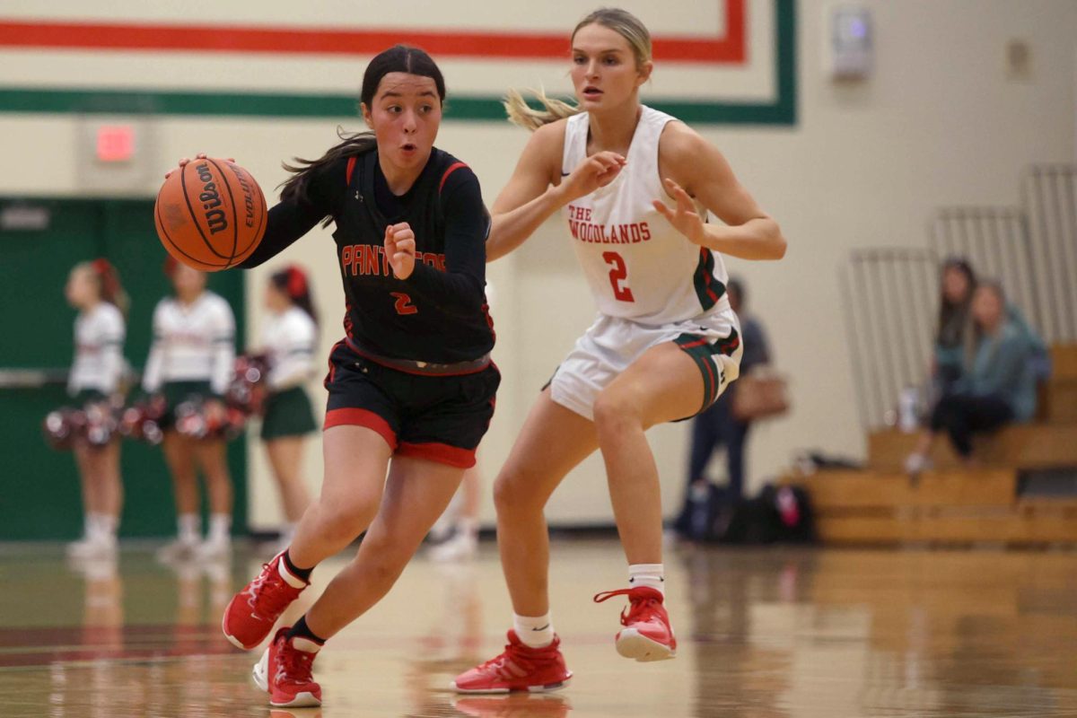 PUSH+THROUGH.+Sophomore+Alyssa+Manuel+running+forward+with+the+ball+against+Woodlands+on+Wednesday%2C+Jan.+31%2C+2024.+Manuel+was+driving+into+the+paint+to+convert+after+having+just+been+subbed+into+the+game+a+few+minutes+before.+%E2%80%9CFirst+half+I+was+frustrated+with+being+out+for+a+while%2C%E2%80%9D+Manuel+said.+%E2%80%9CWe+needed+to+stop+turning+over+so+much+and+choose+better+passes.%E2%80%9D%0A