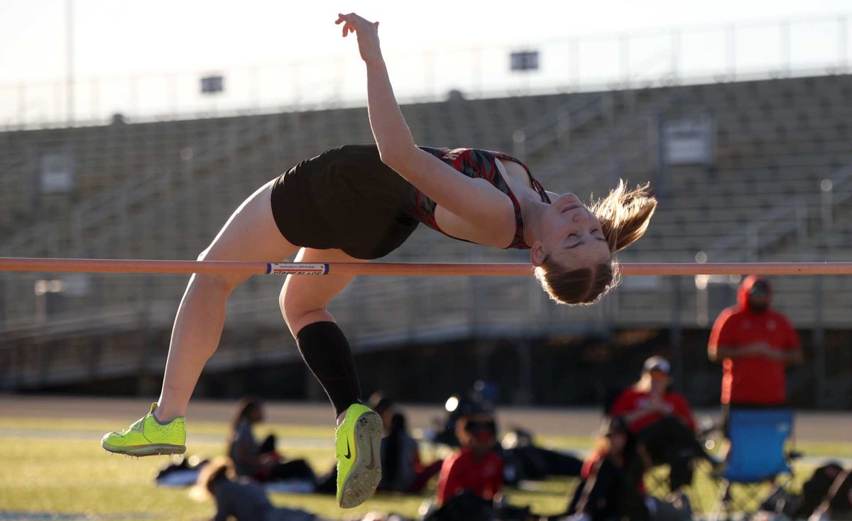 ACROBATIC. Junior Addison Blanks on her last high jump at the Lake Creek track and field meet on Friday, Feb. 23, 2024. Blanks cleared 5’2 feet high jump, setting a new personal record while claiming the gold medal of high jump.