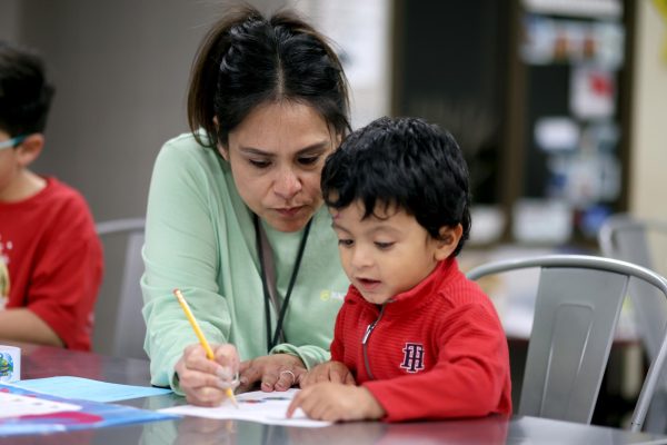 Freshman Counselor Sophia Meza bonds with her youngest son at the pen pal station on Saturday, March 2, 2024 at Caney Creek high school. Mrs. Meza has two kids, the youngest being named Marcel turning 3 on March 15 and the oldest is named Alonso who is 9 years old. “I really enjoyed and was amazed by the variety of activities available as well as the people who were facilitating the event, since they were very attentive to my children.” Meza said.