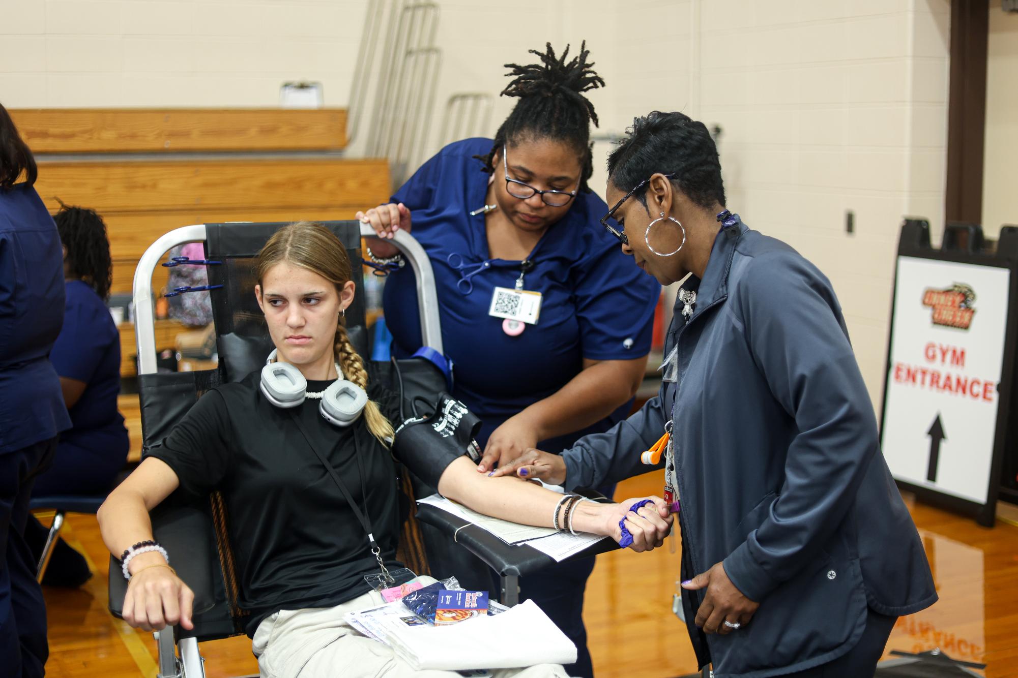 YUCK! Junior Riley Blanks looks away from her arm while Nurses point out veins on her arm at the blood drive on Sept. 4. Blanks wanted to donate blood to prepare herself for what to expect her senior year, so she can earn her blood drive chord. “Me and my sister, we agreed to do it together,” Blanks said. “I know that blood is gonna go towards something like, it'll be used for something important, hopefully, can save a life or help somebody.”