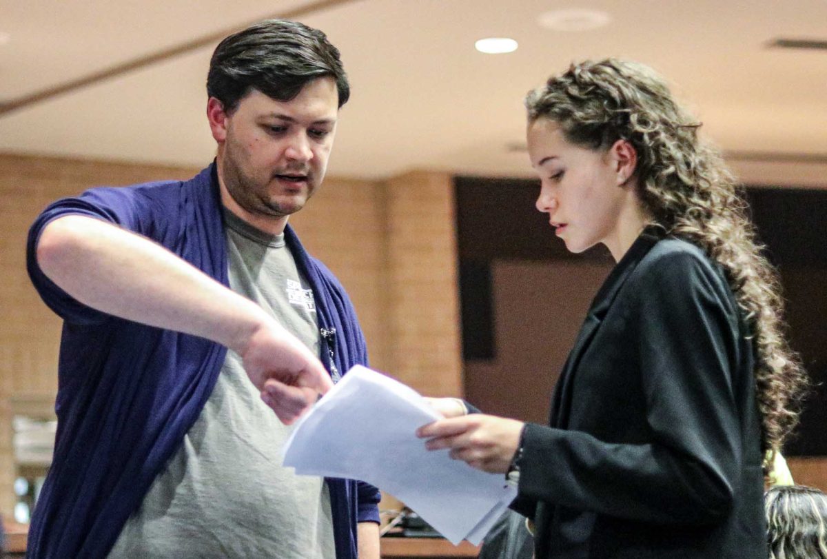 Stephen Green, assistant debate coach, works with freshman Ava Aldridge at the Klein debate tournament Sept. 23, 2023. Green specializes in Lincoln-Douglas debate, individual speaking events and speech presentation. 