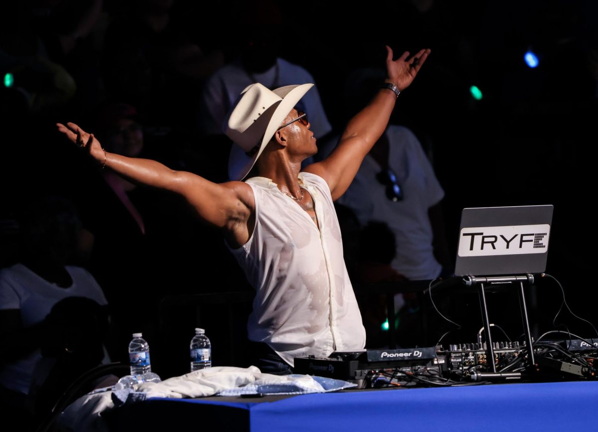 HEAR THE DEMOCRACY. Dallas Native DJ Tryfe holds his hands in the air while attempting to energize the crowd at the Kamala Harris Rally in NRG Stadium on Oct. 25. Tryfe has been DJing for 10 years, but stated this was the biggest audience he has ever performed.