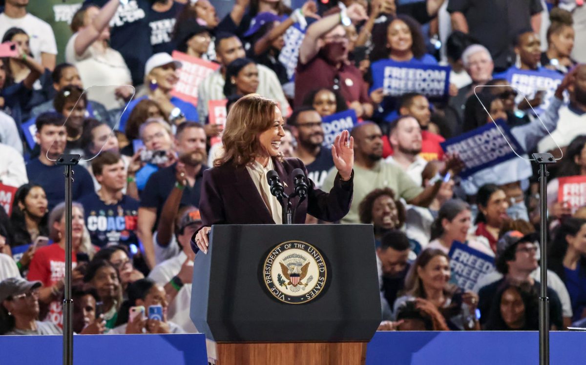 CYA HATERS. Vice President Kamala Harris waves goodbye to a Trump supporter heckling from the stands at her rally in NRG Stadium on Oct. 25. The heckler was met with loud boos from the crowd and was escorted out of the stadium by security.