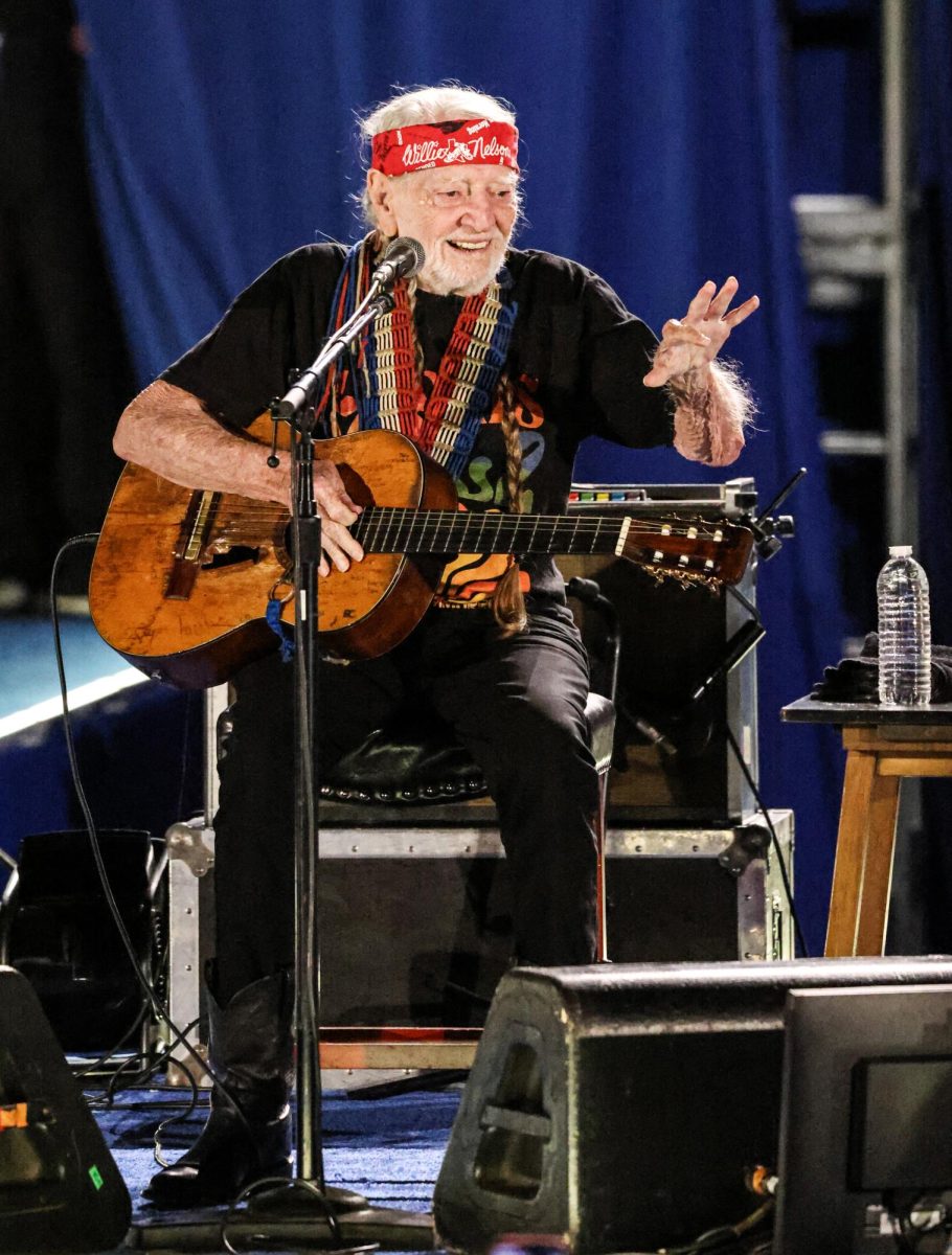 SINGIN’ FOR RIGHTS. Country Singer Willie Nelson sits on stage with his guitars waving to the audience at the Kamala Harris rally held in NRG Stadium on Oct. 26. Nelson endorsed Harris for president, and performed “Mammas Don't Let Your Babies Grow Up to Be Cowboys” and “On The Road Again.”