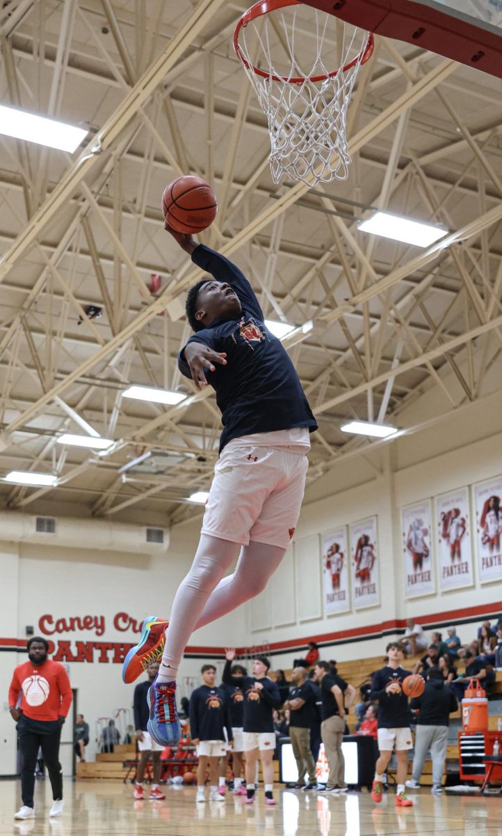 AIR. Senior Christophoper Gulliory going up for the dunk during the pregame warmups against Kingwood Park High School on Tuesday, Nov. 12, 2024.  