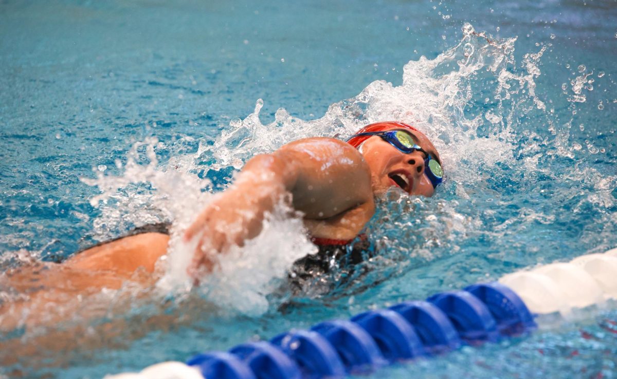 HOLDING ON. Sophomore Maeve MacDonald swimming freestyle at the New Caney Invitational on December 6th, 2024.