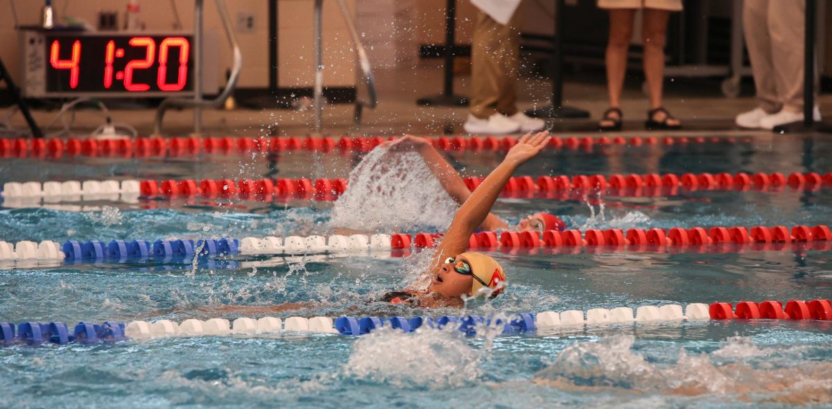 LAPPING. FreshmanRaelyn Baier swimming backstroke at the New Caney Invitational on December 6th, 2024.