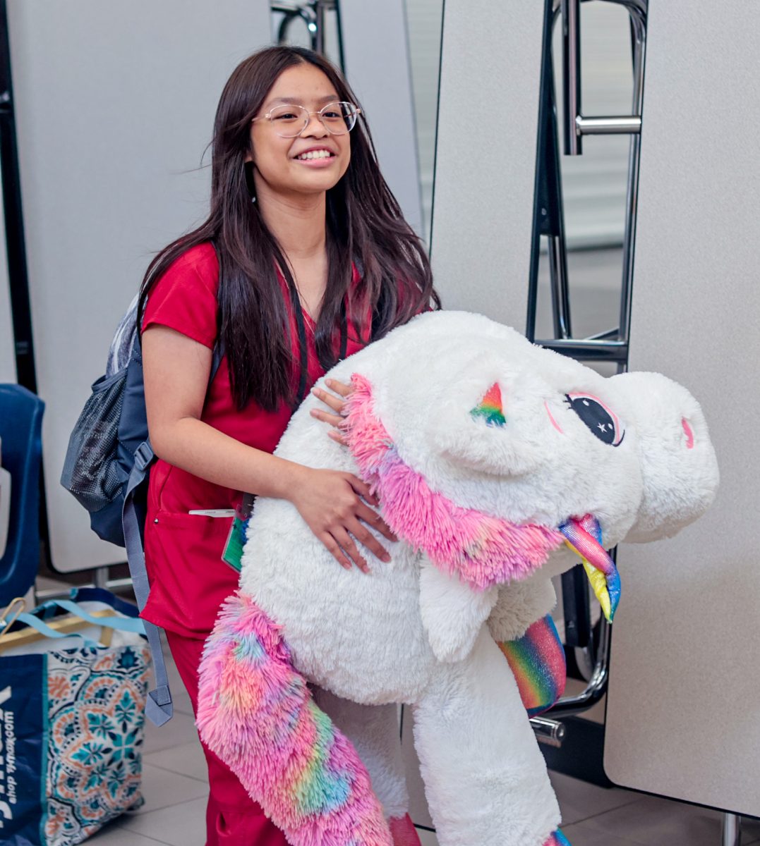 FLUFFY! Junior Zia Brianna Carries a giant unicorn pillow that she found at the winter thrift store held by STUCO on Dec.12. 