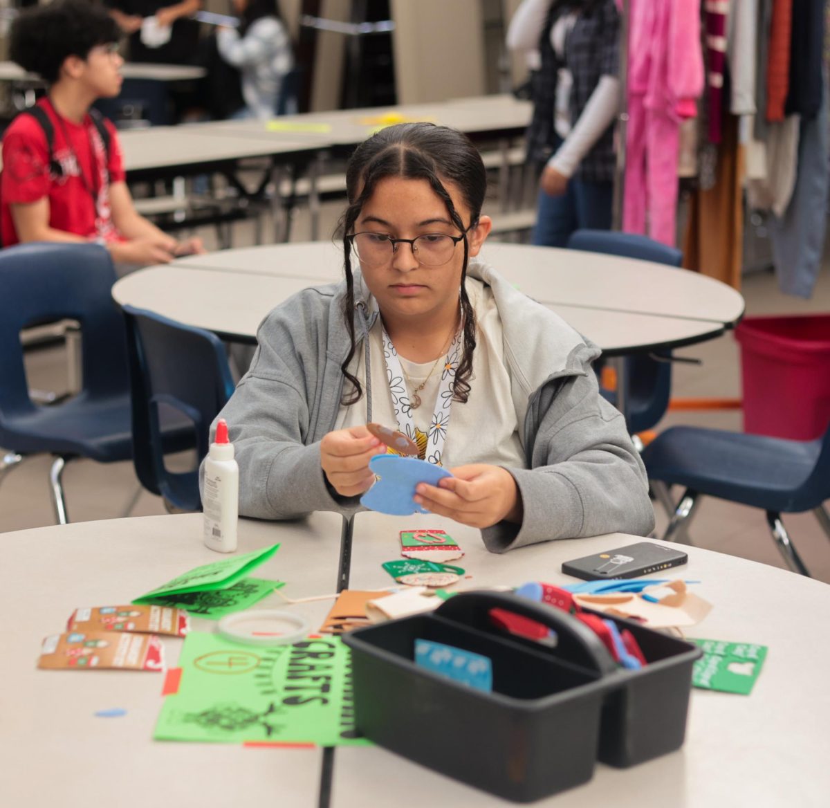 CRAFTING UP. A Student sits at a table making DIY felt ornaments at the winter thrift store held by STUCO on Dec. 12. The event consisted of multiple activities outside of the thrifting, all provided for free by STUCO.