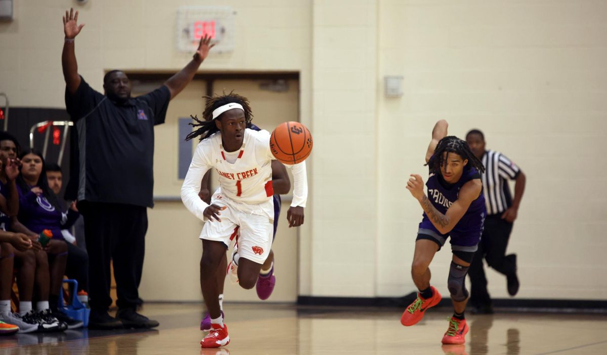 TO THE HOOP. Junior Howard Ruffin runs with the ball, leaving the opponent behind in Friday’s game against Dayton High School on Nov. 15, 2024.