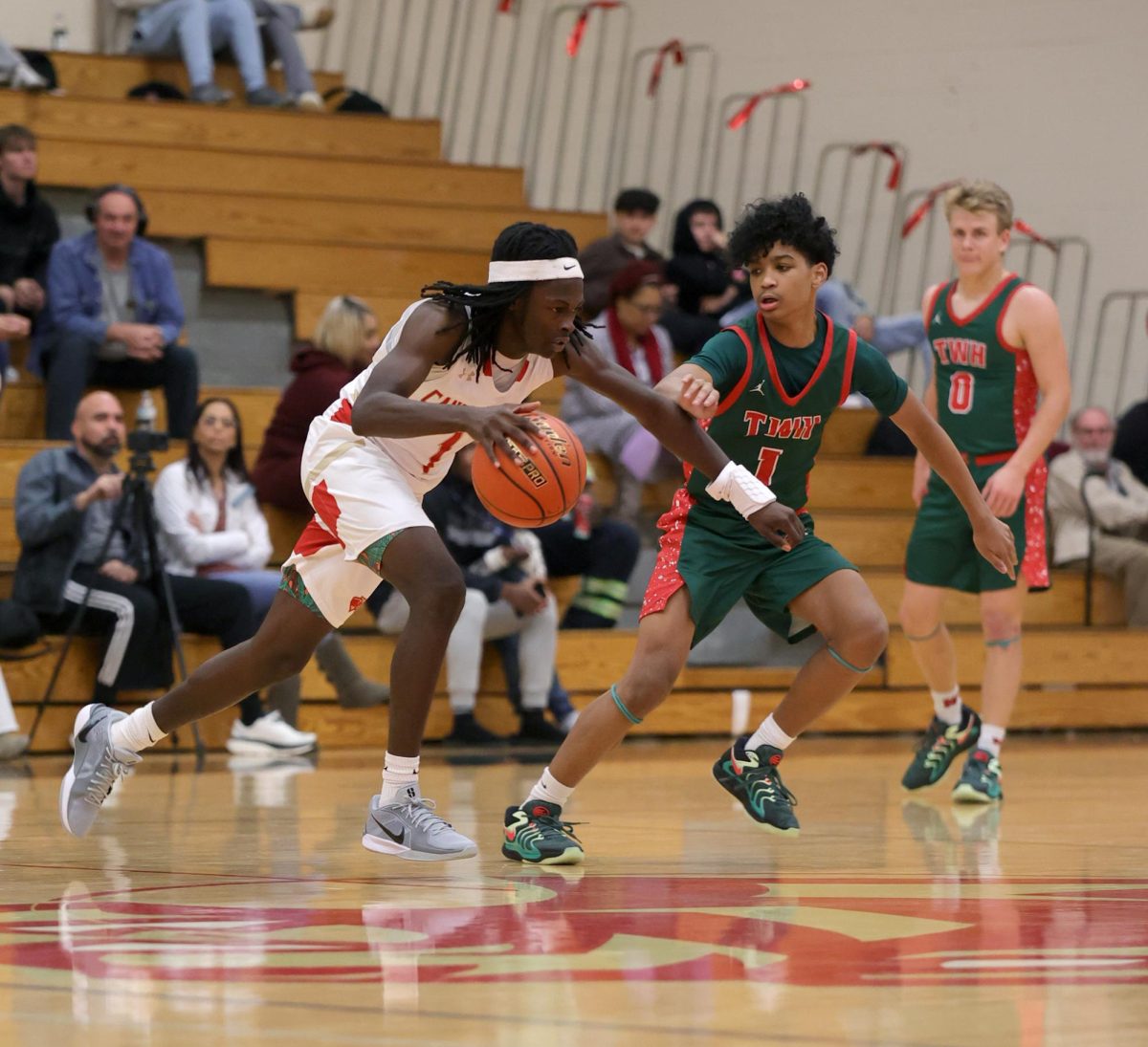 RUN IT. Junior Howard Ruffin is dribbling the ball trying to make a play happen against The Woodlands on Dec. 3, 2024.