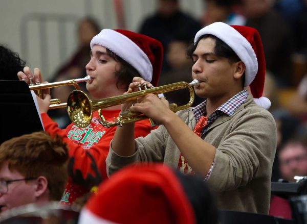 FEELING JOLLY. Senior Eliel Tristan is feeling the holiday spirit as he plays the Trumpet during the Wind Ensemble band  performance on Dec. 5, 2024.
