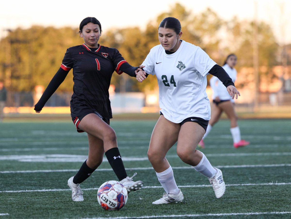 DRIBBLE. Sophomore Amy Zarate trying to dribble past the Clear Fall defender on Saturday's game against Clear Fall on Jan. 11, 2025. Zarate attempted to successfully dribble past the defender but was unsuccessful and lost possession.