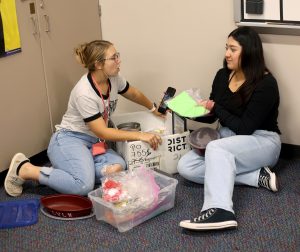 Junior Addison Riden speaks with another StuCo member while putting supplies together on Sept. 24. StuCo runs majority of school events such as, prom, hoco, donations drives, etc.