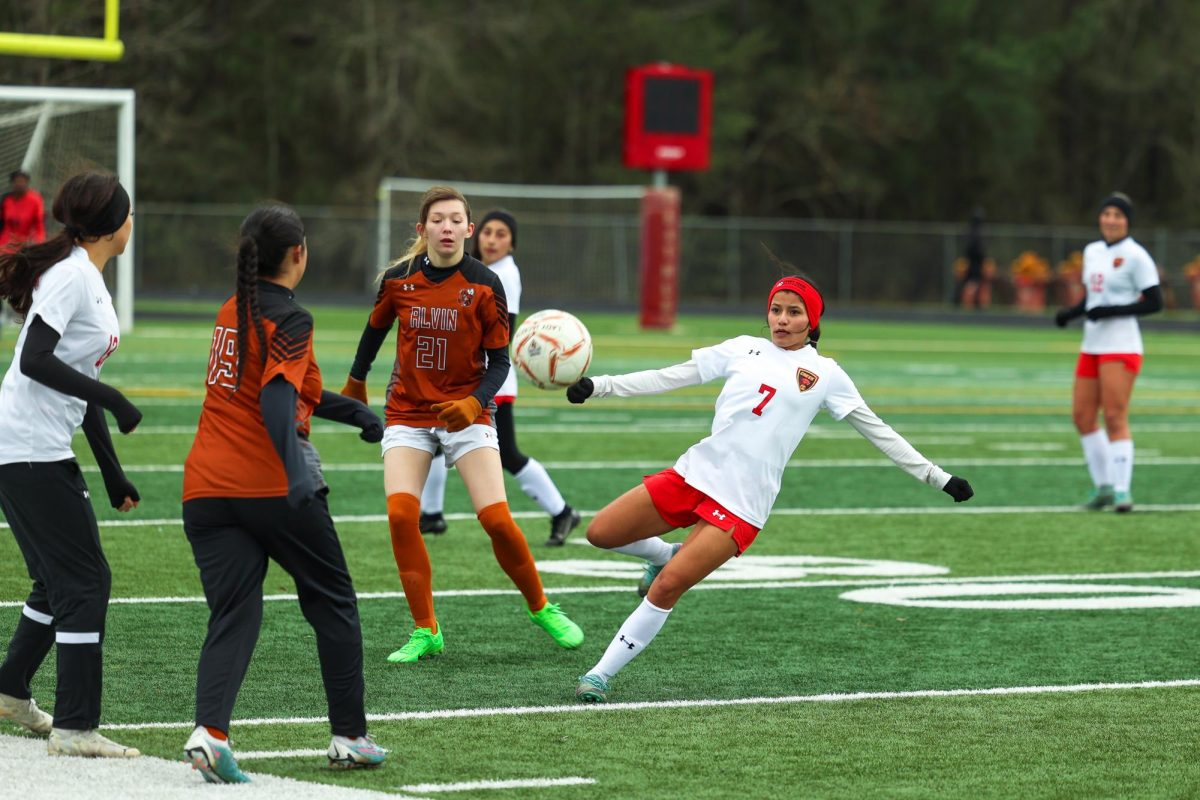 INTERCEPTING. Ensuring the opponents won't get the pass, senior Elizabeth Sanchez intercepts the ball in Friday's game against Alvin High School on Jan. 10, 2025. Throughout the game, the ball was going back and forth from each end, each team was trying to convert on a goal, but led to the final score being a 0-0 draw. “Alvin was giving us a hard time,” Sanchez said. “I think we needed to connect a little more.” During the second half of the match Sanchez was put back in and later on got kicked on the nose.