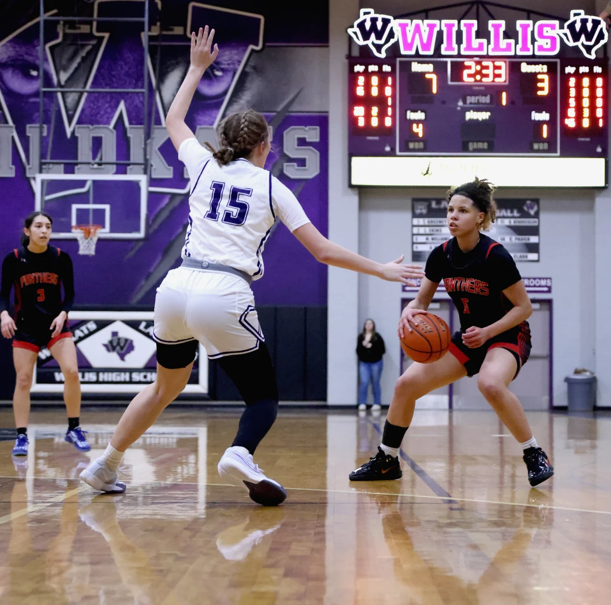 SCORE. Freshman Kora Vrionis looks to get toward the basket against Willis on Wednesday, Jan. 15, 2025. This is one of Vrionis best plays this game as she drives in then passes the ball to her post player Megan Schreck. “Being on Varsity is still a learning process, but I hope to continue making great plays with the team.” Vrionis said. 