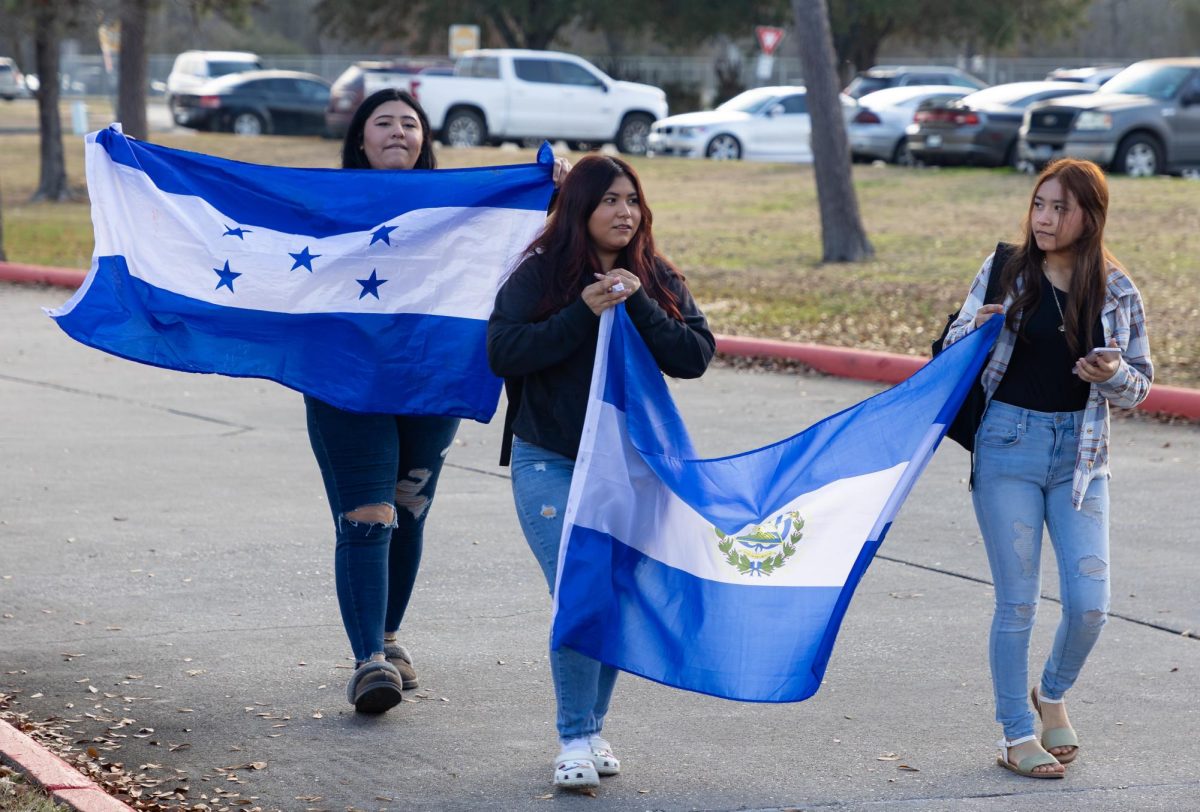 THIS IS US. Students walk down the driveway leading the front entrance as part of the protest Tuesday, Feb. 4, 2025. 