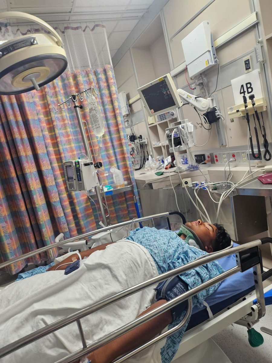 Junior Juan Moreira lays in a Texas Children's hospital bed after a spinal fracture on Aug. 15.