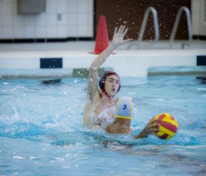 BLOCK. Mark Fullen (11) blocks a play from No. 3 at the Aldine Tournament for water polo on Friday, Aug. 15. This led to Caney Creek intercepting the ball and scoring. “This was a great start to the year,” Fullen said. “I’m glad we were able to start the year with a win and that I was able to help with that.”