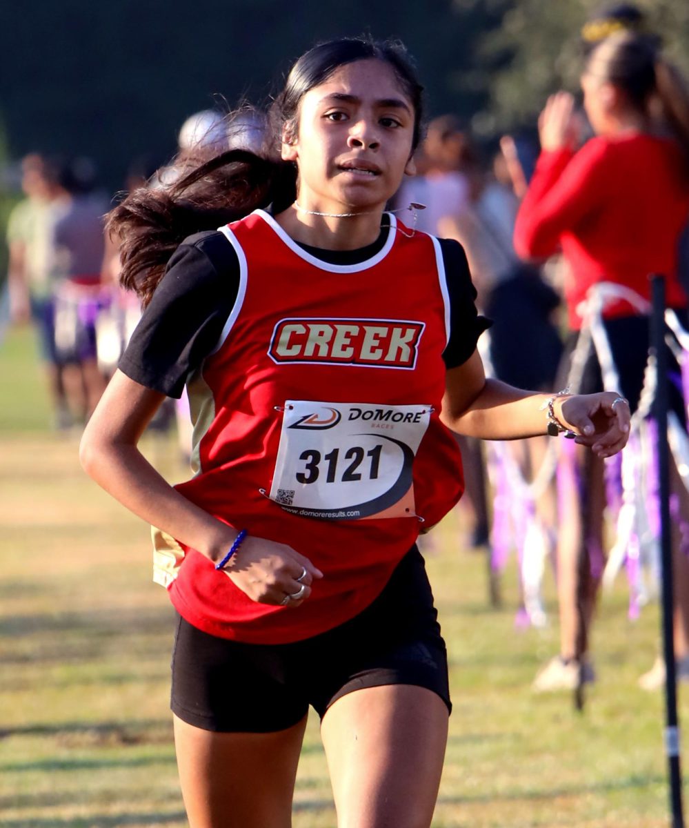 RESOLVE. Senior Andrea Rangel nears the finish line on Sep. 13 at the Dayton Invitational Meet. Rangel achieved her 5K Meter seasonal record time of 23:41. “Hearing my coach shouting to keep going had kept me motivated to keep pushing during the race,” Rangel said.
