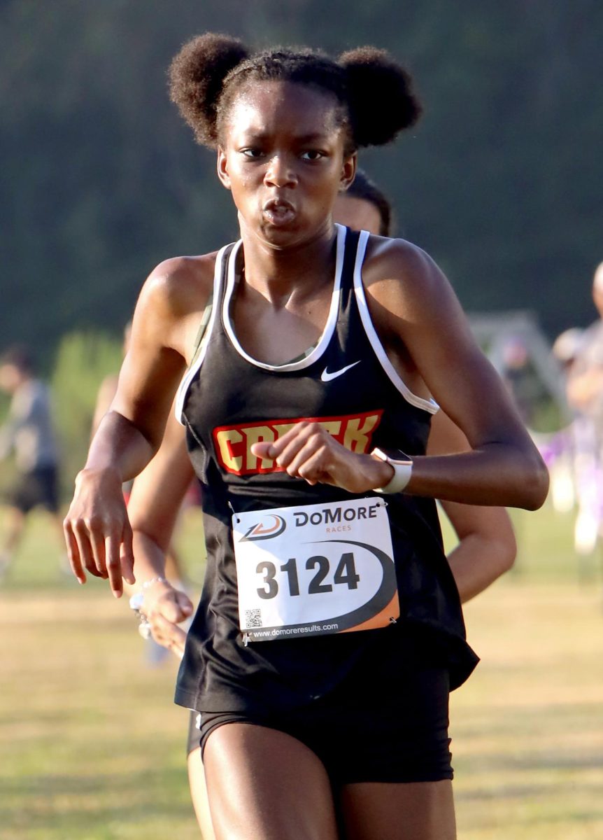 PUSHING FORWARD. Freshman Keira Davis finishes her 5K Meter run on Sep. 13 at the Dayton Invitational Meet. Keira blasted past the finish line as if like a rocket.