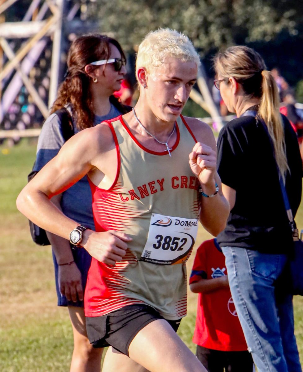 FINAL STRETCH. Senior Logan Berrgen begins his final lap on Sep. 13 at the Dayton Invitational Meet. Berggen would go on to achieve his new 5K Meter seasonal record time of 16:00. “Running during that final lap was very scary and had my heart racing," Berggren said. “When I found out I got my seasonal record of 16:00 I was happy. It was a big accomplishment and I’m aiming towards 14:00 next time.”