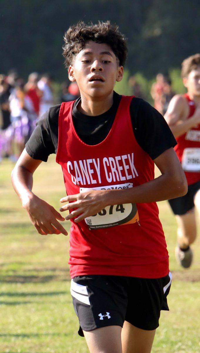 GAZING THE FINISH. Sophomore Misael Vazquez approaches the finish line on Sep. 13 at the Dayton Invitational Meet. Even in the blazing sun, Vazquez eyes the finish line and continues to push towards the end.