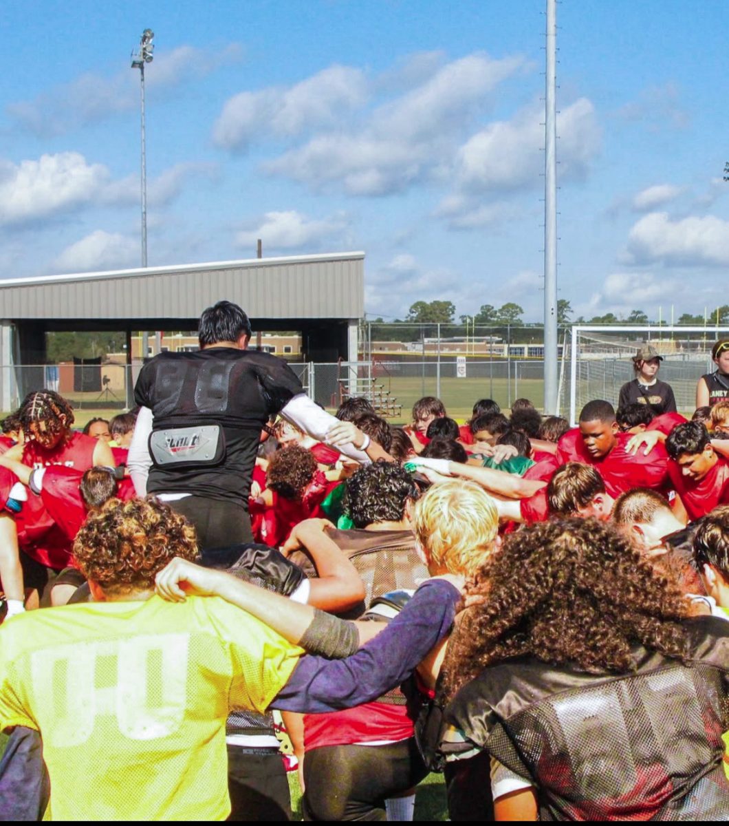 The football team prays as junior Juan Moreira is paralyzed following a injury in a scrimmage Aug. 16. 