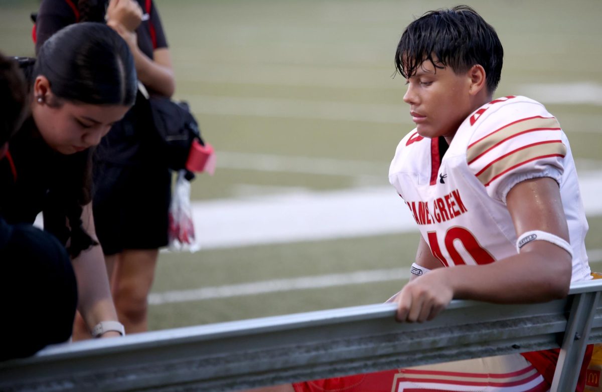 HELPING HAND. Freshman Jaycob Rodriguez was injured while playing in the game at Montgomery High School on Sept. 04, 2025. He had been injured while landing out of a  jump and twisting his ankle while landing. “The trainer did a good job, since I couldn't feel it hurting anymore,”  Rodriguez said.