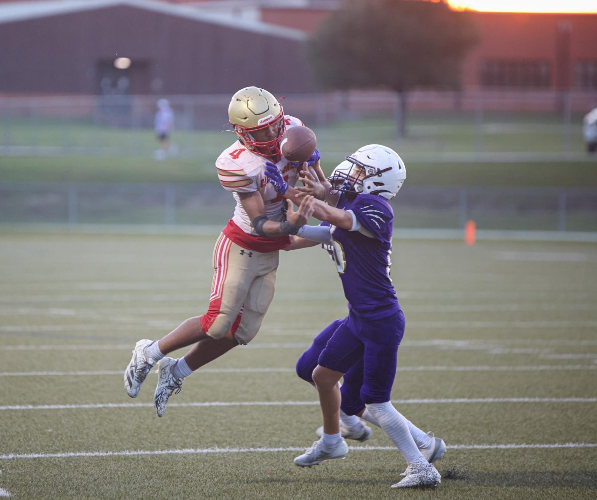 INTENSE COLLISION. Freshman Kenneth Gabaldon tries to catch the ball that was thrown by his quarterback on Aug. 4, 2025. Gabaldon makes a touchdown after catching the ball through opponents hands. 