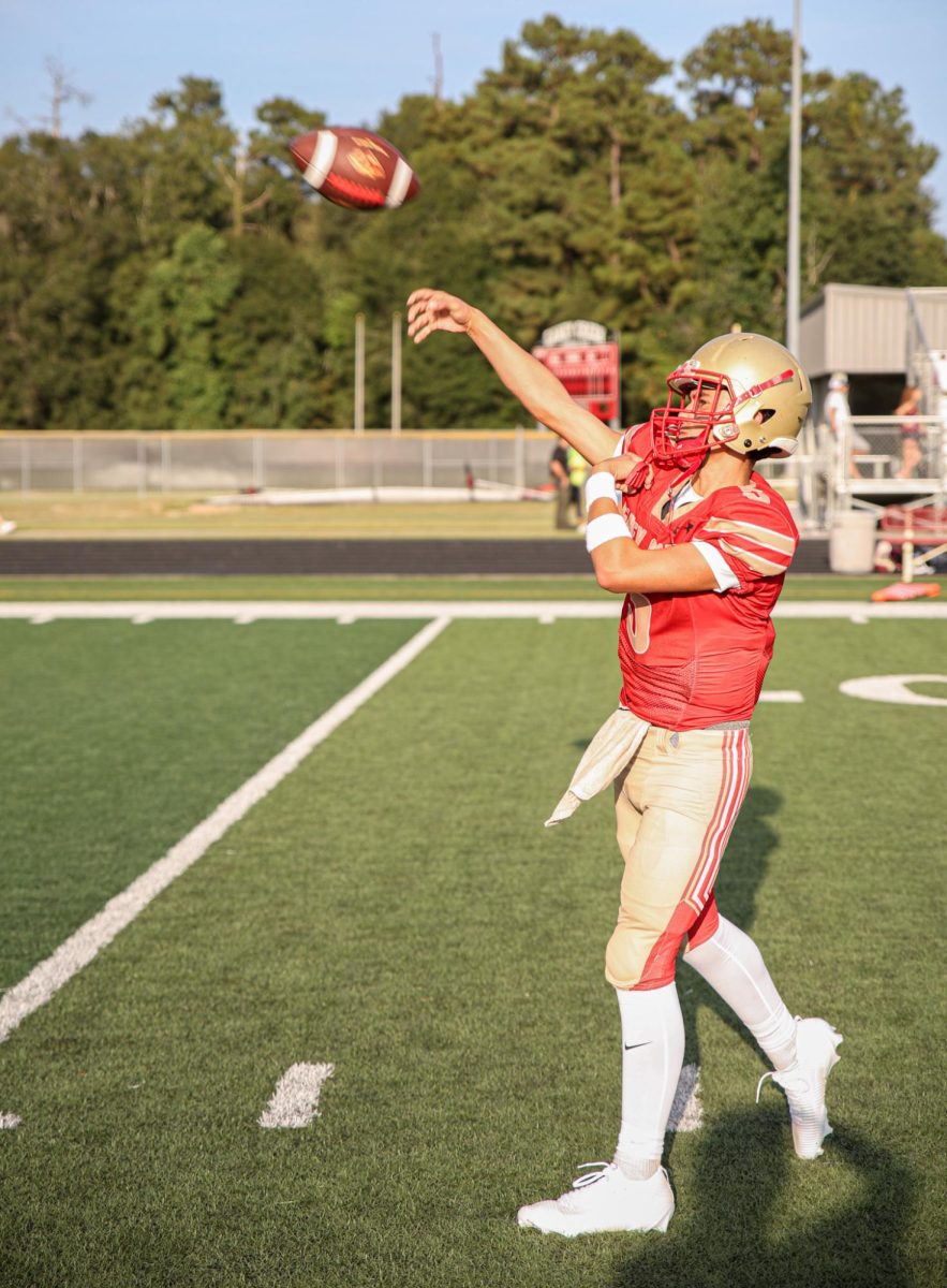 Freshman Leland Kincaid threw the ball to his teammate during their warmups against Waller on Aug. 28, 2025. “My mindset before the game is focused on what the other team’s defenses are doing," Kincaid said. “Me and the coaching staff's communication is always important, me and the coaches always need to be on the same page to succeed in a football game.”
