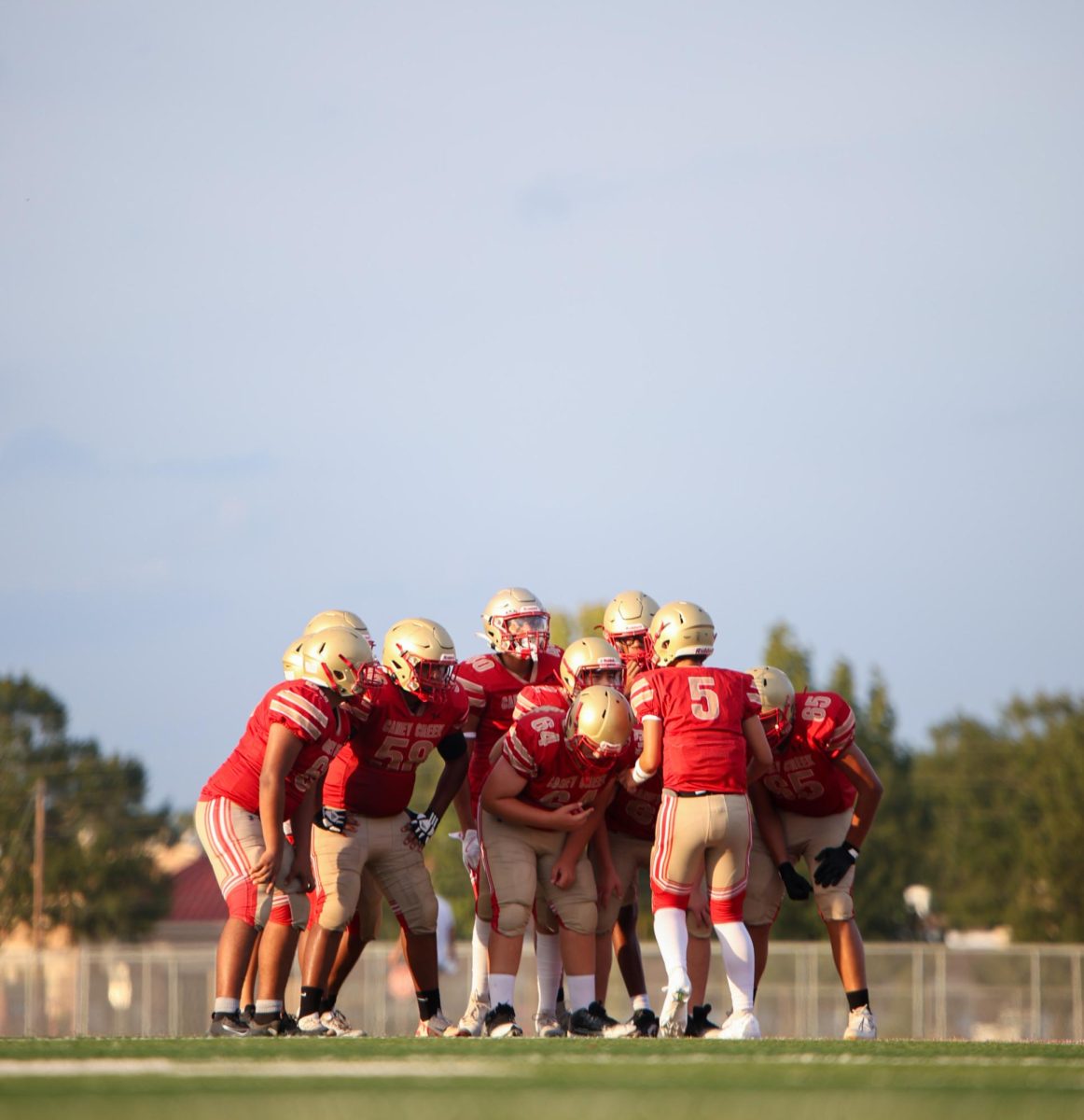 Freshman Leland Kincaid makes his team huddle up with him on the field against Waller on Aug. 28, 2025. Kincaid does this before every game to make sure his teammates know the play before they break out. “We huddle up the offense before every play to discuss what formation to line up in so everyone knows what they need to do for that play call,” Kincaid said. “I tell my huddle the cadence the formation then what play we’re running out of that said formation. Everyone has different jobs on different plays. We might even change something up mid game. Everyone has to know how to do their job to get into the end zone.”