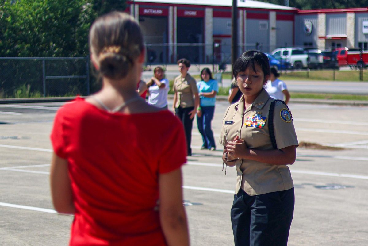Keilly Santos (11) was demonstrating her skills to a ROTC student on Sept. 10, 2025. ROTC members are getting ready for an upcoming drill meet. Santos has been part of ROTC for years now and might use this for the future as backup. “I am more focused on getting into college but if anything I would join the Navy as a backup plan,” Santos said. “ I would highly recommend ROTC for people. It is very fun to talk to new people and have new experiences, plus free food? I say it's a win honestly.”