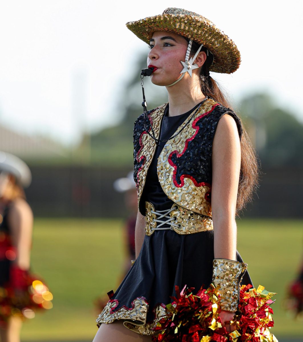 LEAD ON. Bianca Castro (12) guides her team to the football field as the Kernel. The Kernel in Starlets is the head officer which cleans up the team, teaches the dance routines and gives instructions to the team during football games.  “It’s a lot of pressure to have everyone on my team trust me,” Castro said. “but it's slowly getting better as I get used to it.”