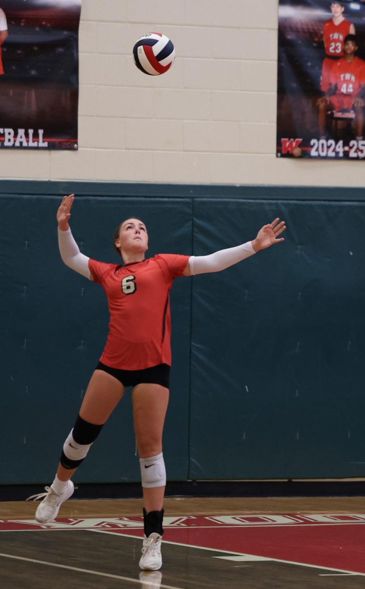 OVER THE NET. During the game against The Woodlands on Tuesday, September 2, Raleigh Synder (9) was serving the ball, causing them too later on get a point.