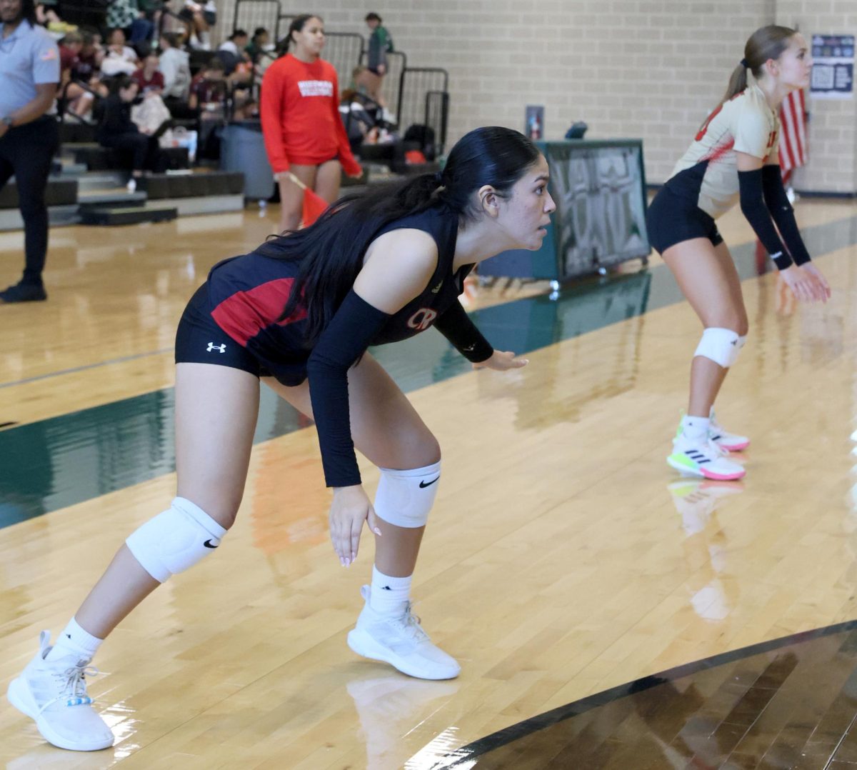SMACKDOWN. Junior Fernanda PerezNegron hits an outstanding serve for the Caney Creek team, PerezNegron said “I think the main objective is to hit the ball to a point where you can take advantage of the other team to confuse them. From how the teams were, I was confident we were going to win that match.” 