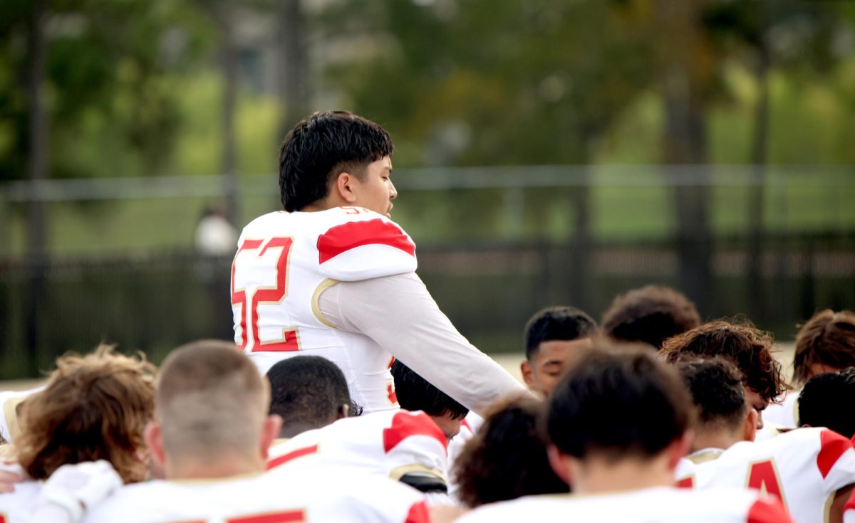 FAITHFUL HUDDLE. Senior Ricardo Pulido stands over the whole team and prays over them on Sept 12, 2025. Puido started this tradition at the beginning of this season. “ I always ask God to protect us from evil and that he puts Caney Creek on the spot to show us who we are,” Pulido said. “I also pray for the rest of the seniors because we have such little games left, and we need to ball out for each other because at the end of the day, we’re all brothers.”