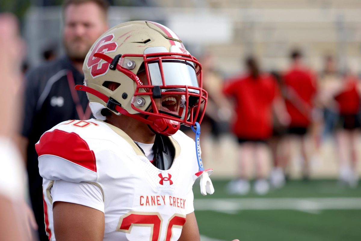 PRE-GAME HYPE. Senior Rigoberto Macis gets the team pumped up before the game on Sept. 12, 2025. The whole team yells and moves around before their warm-ups to get hype. “I was yelling to get the whole team's energy up and get everyone pumped up to get ready to play,” Macis said. “My mindset before the game is to focus on my own personal job, and execute to my best ability.”