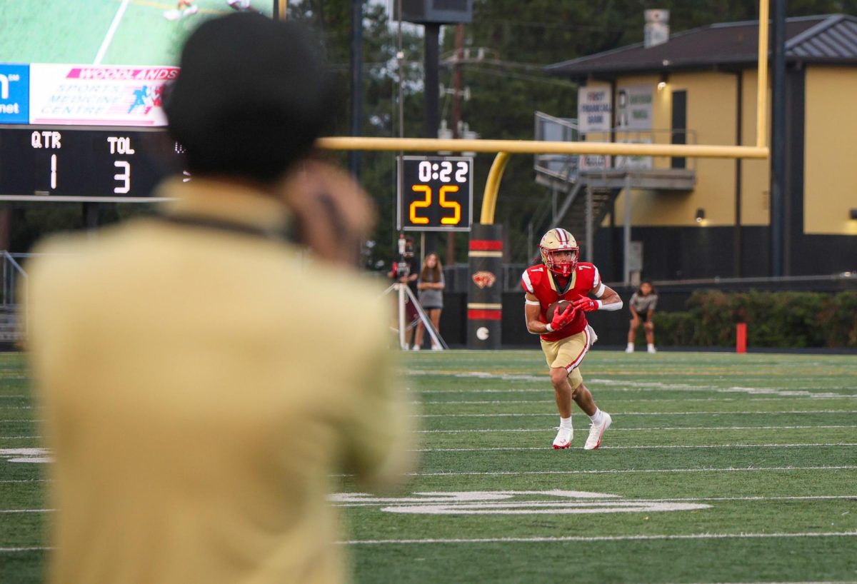 TAKING THE RUN. Junior Chance Koeing ran with the football ball across the field during the Waller home football game on Aug.29.