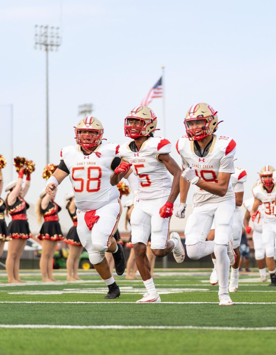 GAME TIME. Senior Isaiah Rivera and his teammates running out on the field to the fight song on Sept 12, 2025. “I was excited to go play with my brothers,” Rivera said. “Just an exciting opportunity to go try my best.”