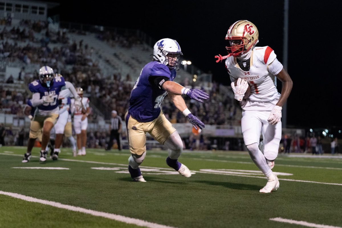 Sophomore Amarien Hughes runs the ball upfield as he looks to gain yards for The Creek. Hughes later helps the Creek push up closer to the end zone!
