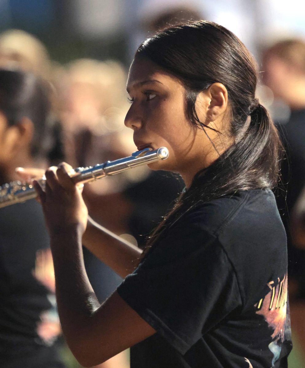 FLUTE FLOW. Sophomore Avril Castro was practicing and preparing for the half-time performance on Sept. 5, 2025 “ I've been in the band for 2 years and yet I get nervous before a performance but I try to breathe in every moment before the performance and during the performance,” Castro said.