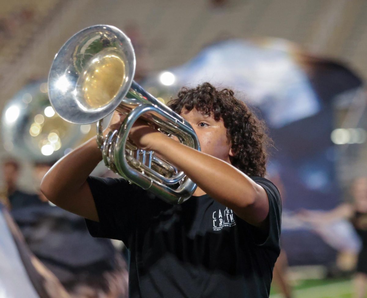 BRASS FLEX. Senior Erick Garcia plays the bariton during the half-time performance on Sept. 5, 2025 “ My goal is to make every moment in the field perfect and play every note correctly and in tune,” Gracia said. 