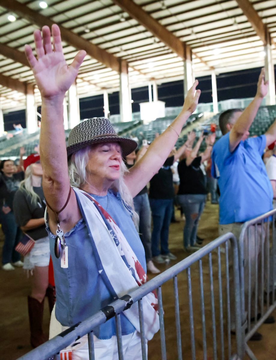 IN MY PRAYERS. Charlie Kirk memorial audience member raises her hands as Christian worship songs play from the speakers of the Montgomery Fairgrounds stadium stage Sept. 30. The service ended off with a group worship to Christian rock, led by Judge Wayne Mack.
