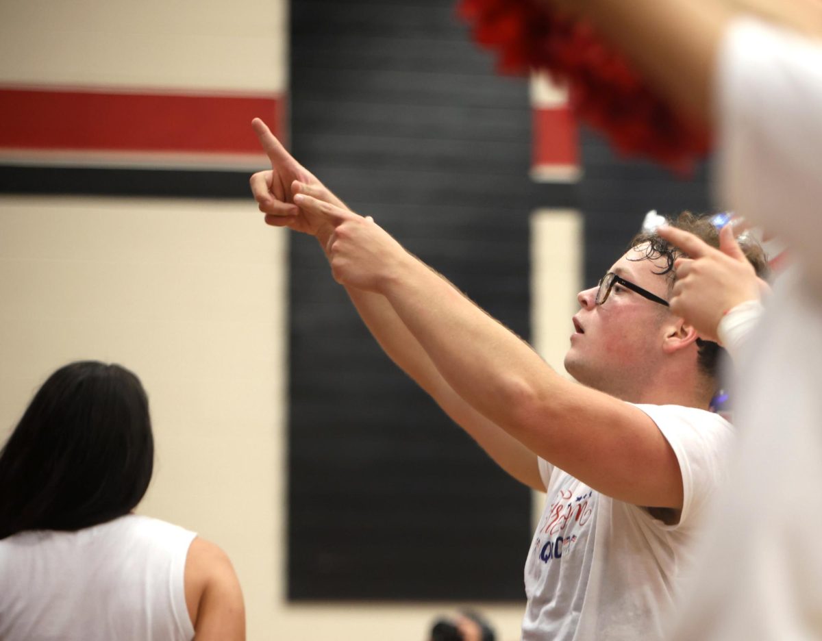 HYPE MODE. Senior Jacob Rhodes points at the senior side telling them it's their turn for the chant at the Pep rally on Sept. 12, 2025. Rhodes hypes the Senior side every time there's a contest against every grade level. “As a cheerleader we get to hype up our side,” Rhodes said. “I always get us to scream the loudest so we win, especially since we’re seniors now.” 