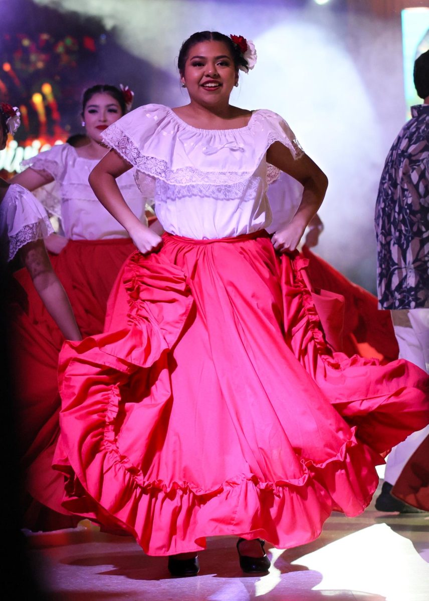 STAND PROUD. Senior Keyla Ayala smiling to the crowd as the Panteras En Fuego team finishes their routine on Sept. 11, 2025.